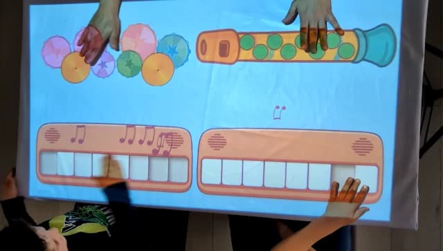 Children playing PLIX interactive music game on a table